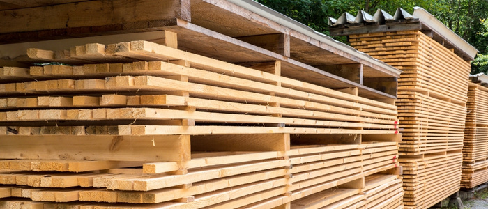 Air seasoning involves stacking timber in a well-ventilated shed or yard where natural airflow gradually removes moisture.